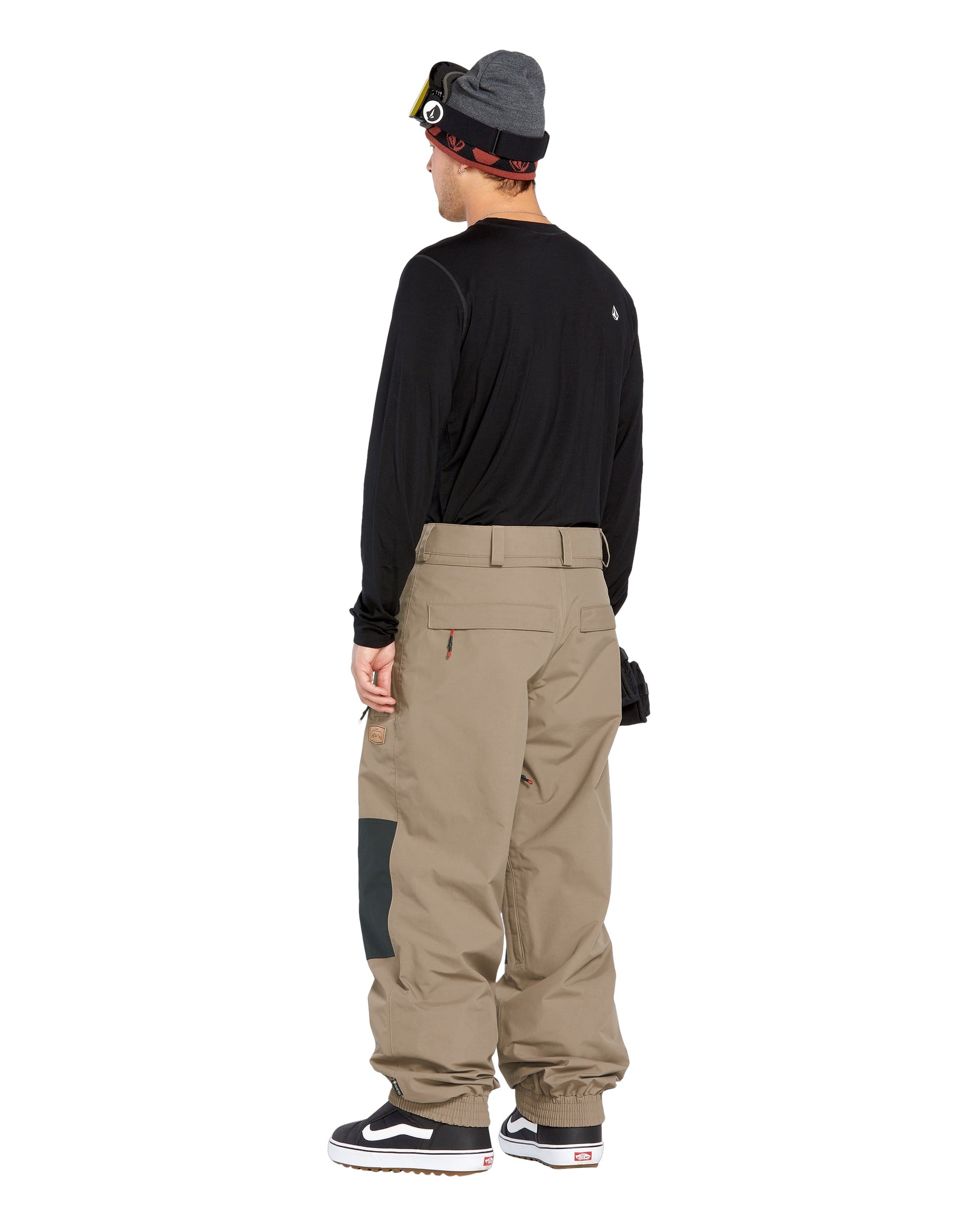Volcom Men's Longo GORE-TEX Shell Pants - A pair of khaki-colored snow pants with a black stripe on the side and a zippered pocket at the back.