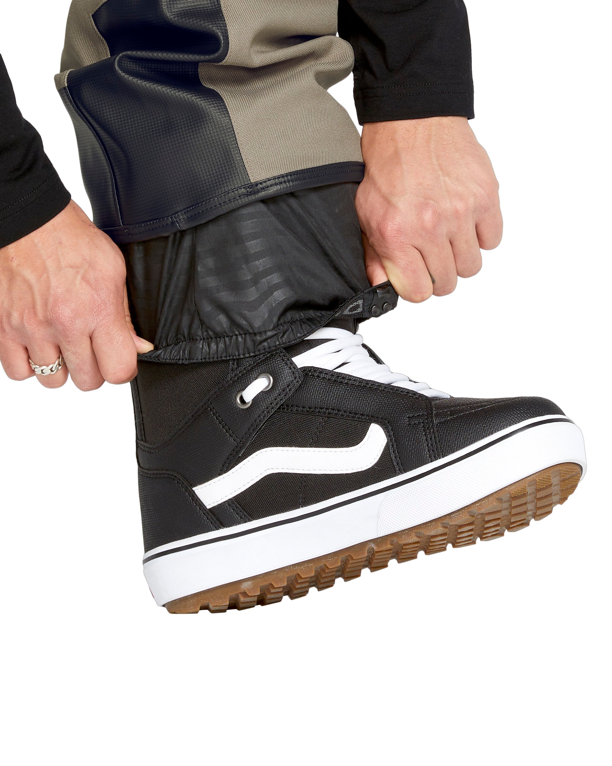 Volcom Men's New Articulated Shell Pants 2025 - Black pants with a subtle pattern of diagonal stripes on the side, featuring a zippered pocket and adjustable cuffs.