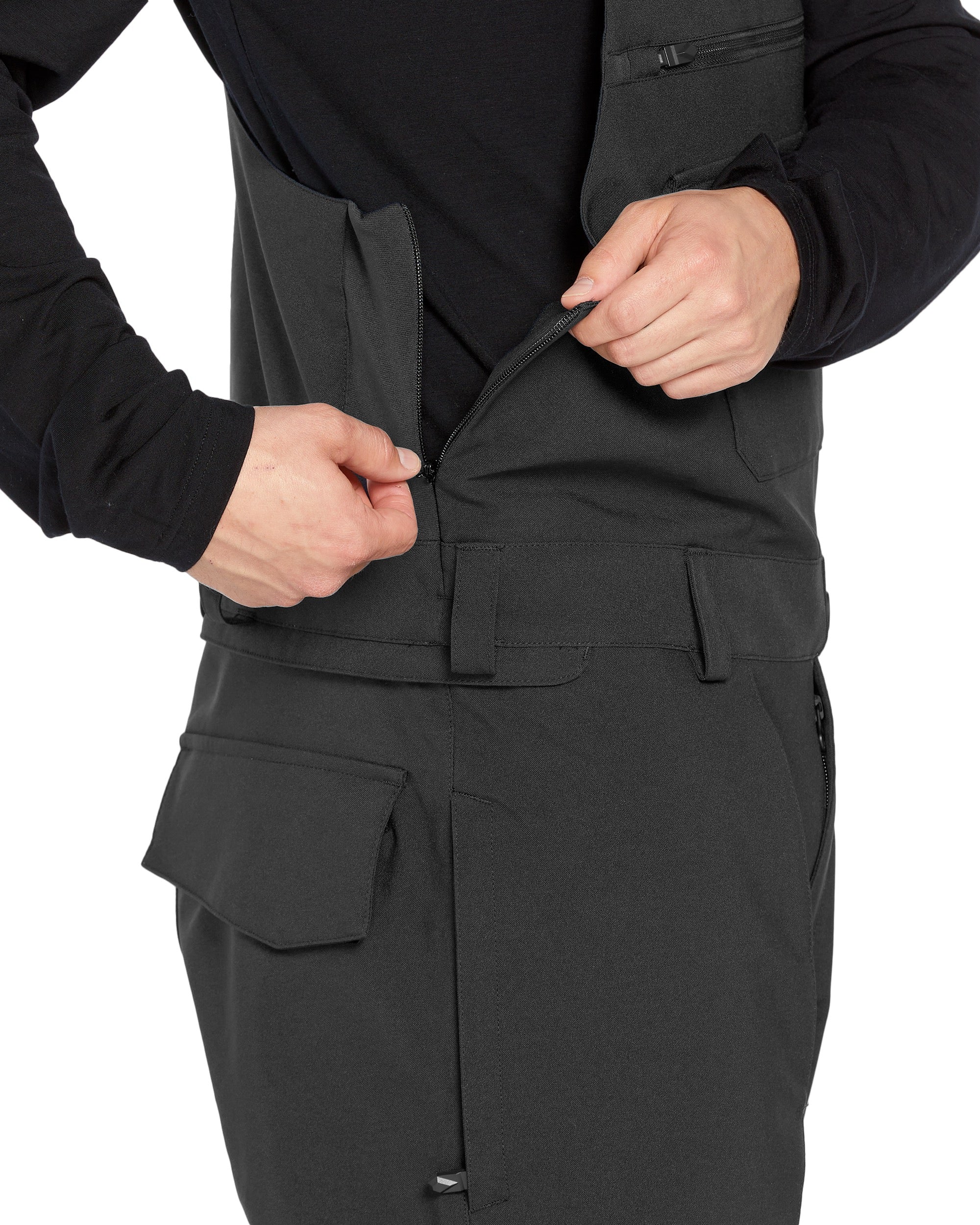 Volcom Men's Roan Shell Bib Overall - A black bib overall with a zippered front and two chest pockets, featuring a small logo on the left breast pocket.