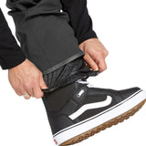 Volcom Men's Roan Shell Bib Overall - A black bib overall with a quilted pattern on the chest and shoulders, featuring a zippered fly and adjustable Velcro straps at the waist and ankles.