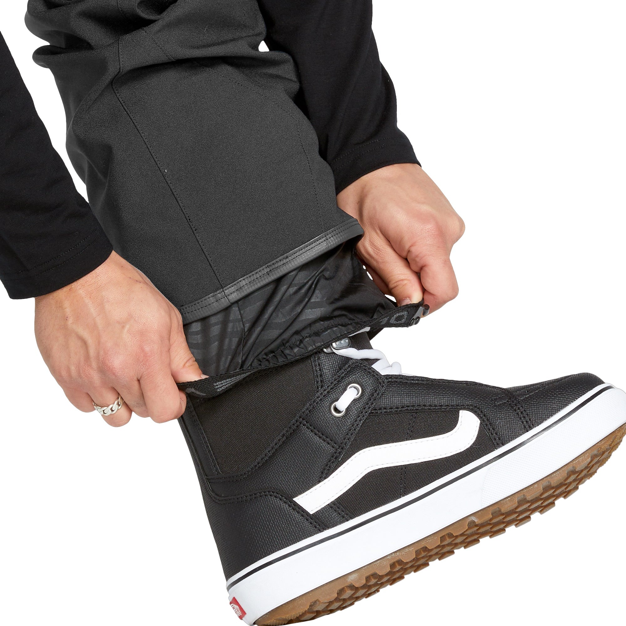 Volcom Men's Roan Shell Bib Overall - A black bib overall with a quilted pattern on the chest and shoulders, featuring a zippered fly and adjustable Velcro straps at the waist and ankles.