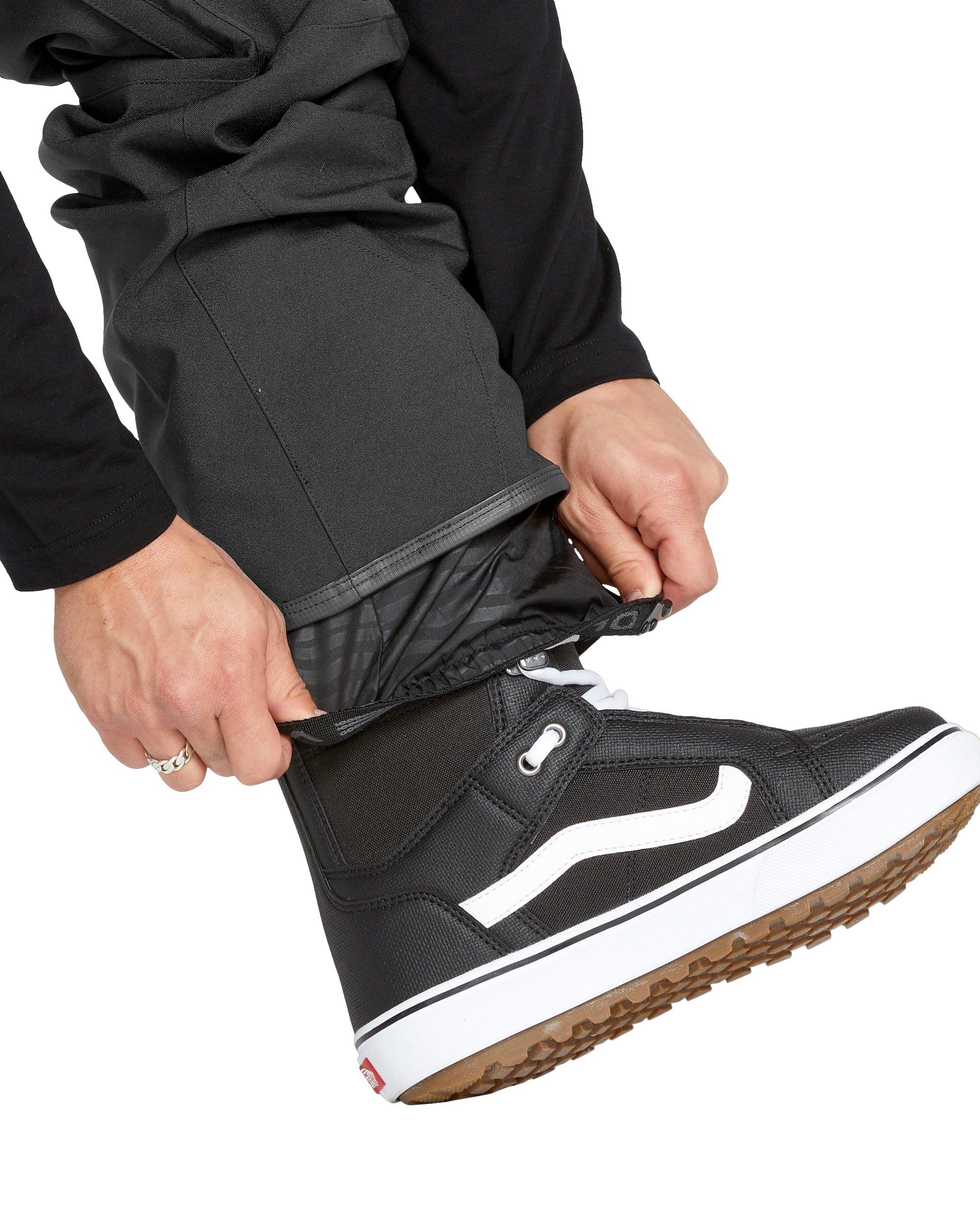 Volcom Men's Roan Shell Bib Overall - A black bib overall with a quilted pattern on the chest and shoulders, featuring a zippered fly and adjustable Velcro straps at the waist and ankles.