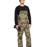 Volcom Men's Roan Shell Bib Overall - A pair of khaki-colored snow bib overalls with a subtle pattern and multiple pockets.