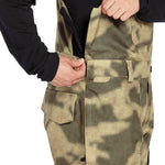 Volcom Men's Roan Shell Bib Overall - A camouflage-patterned overall with a zippered front and two chest pockets.