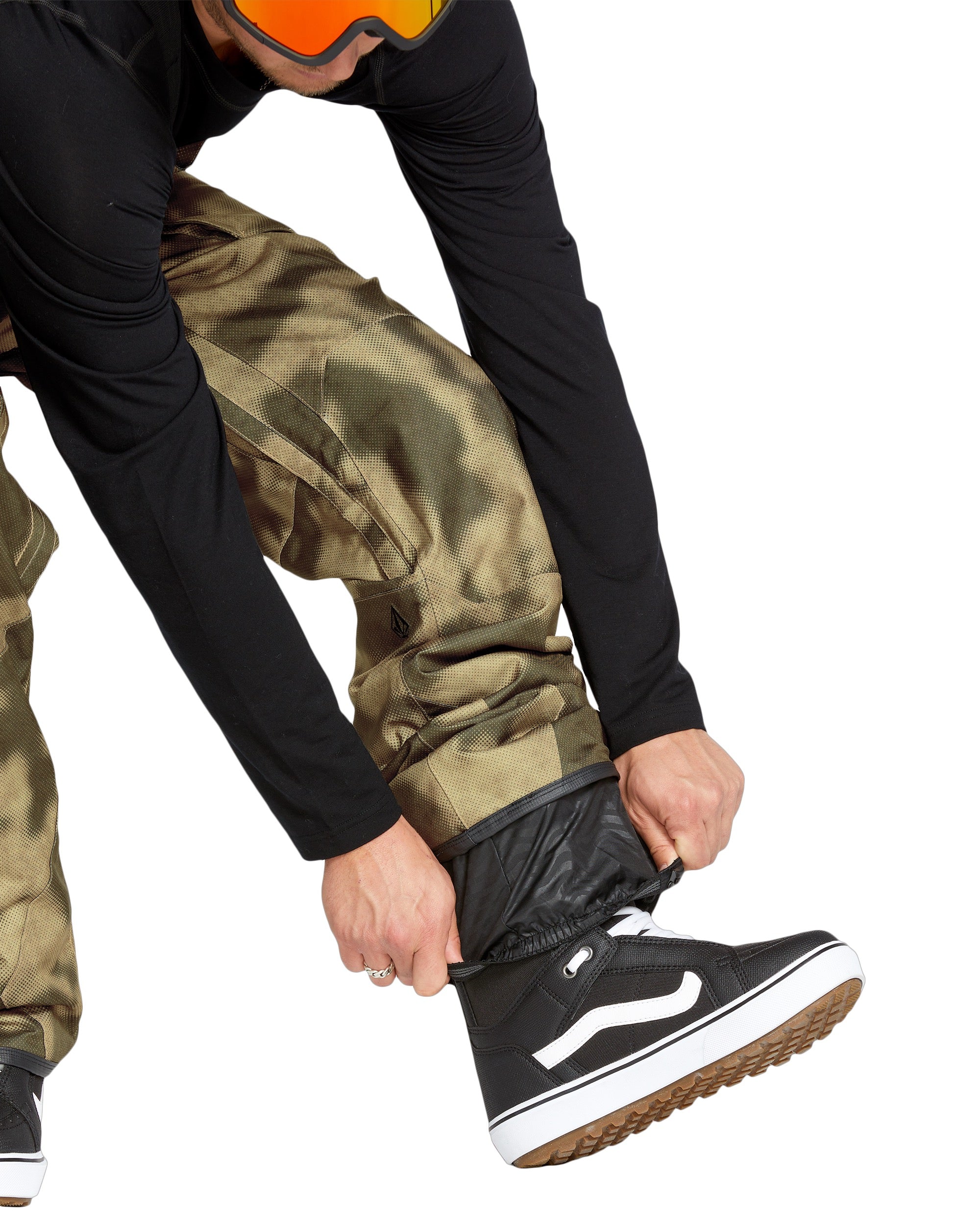 Volcom Men's Roan Shell Bib Overall - A pair of khaki-colored snow pants with a subtle pattern and zippered pockets.