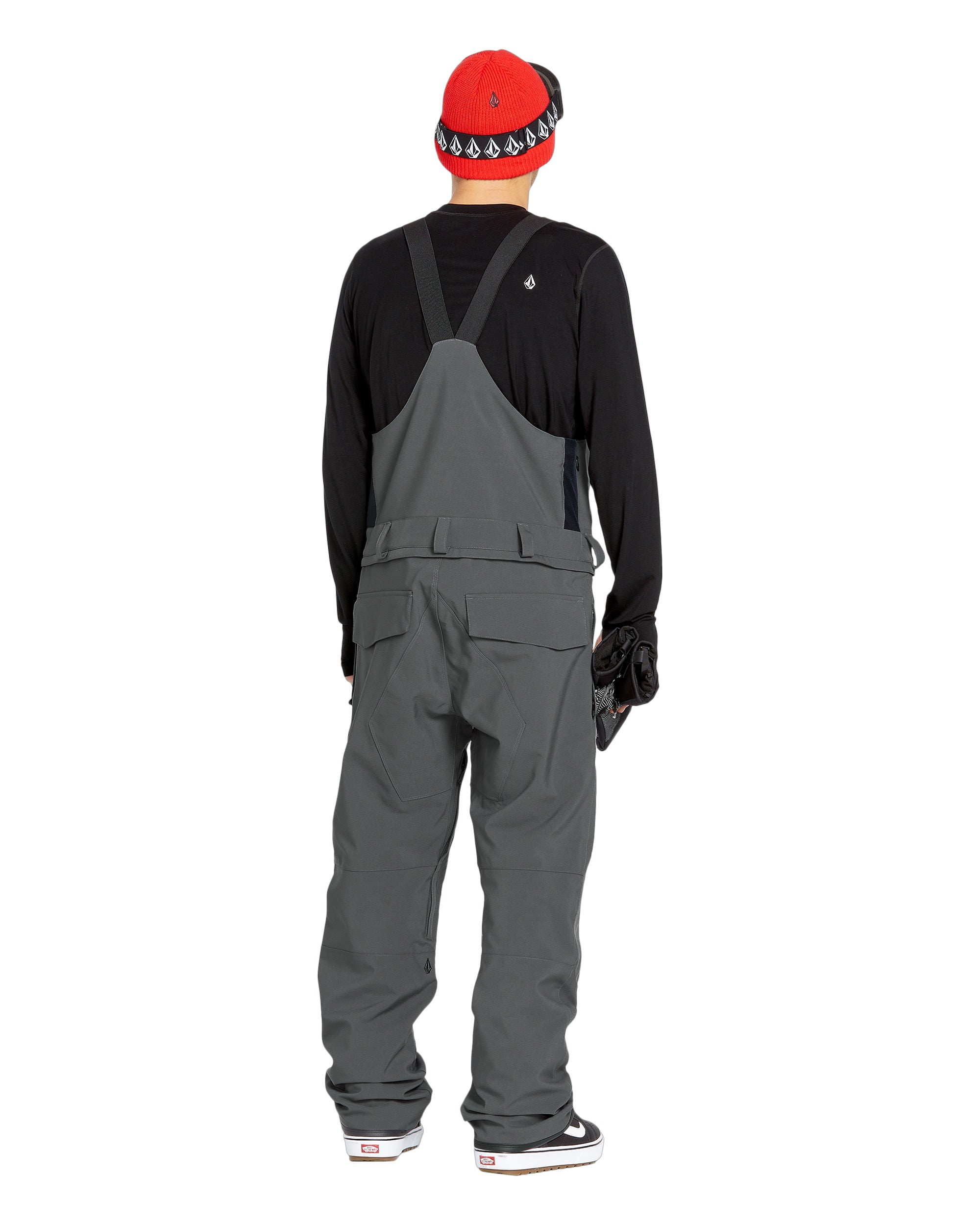 Volcom Men's Roan Shell Bib Overall - A dark gray overall with a black zipper and two front pockets, featuring a white logo on the left chest area.