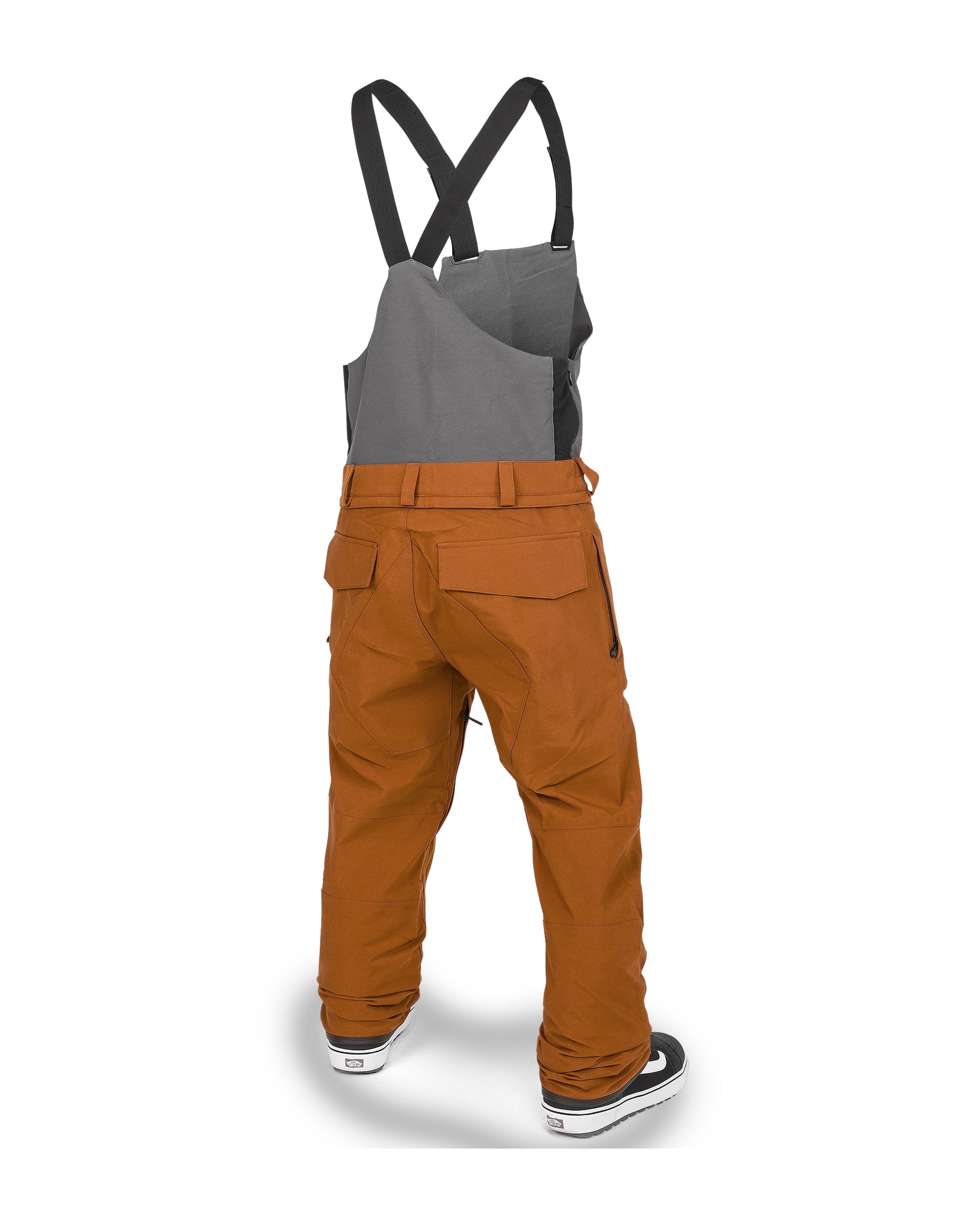 Volcom Men's Roan Shell Bib Overall - A pair of brown snow pants with a zippered pocket on the thigh and adjustable straps at the waist.