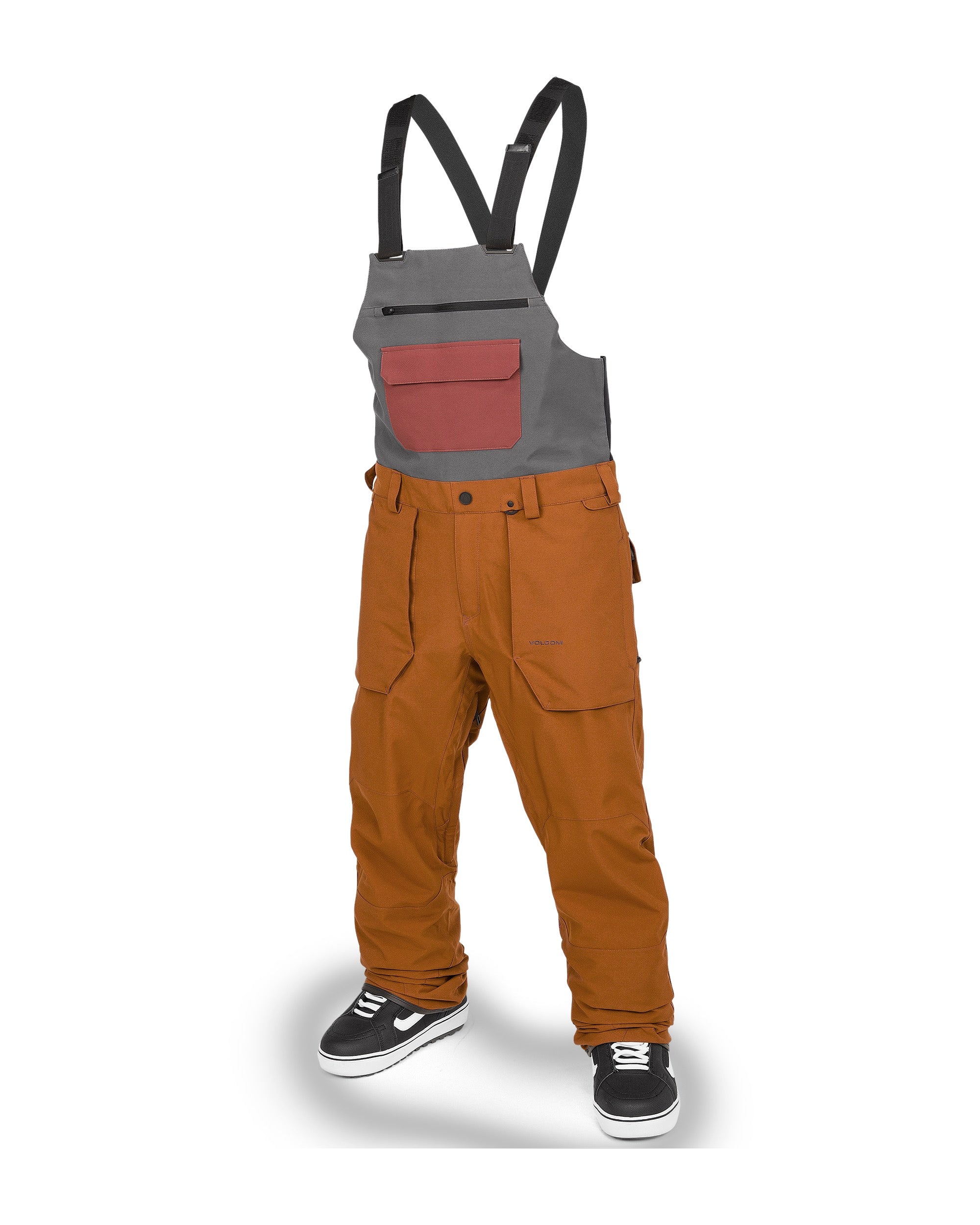 Volcom Men's Roan Shell Bib Overall - A pair of brown bib overalls with a zippered fly and two front pockets.