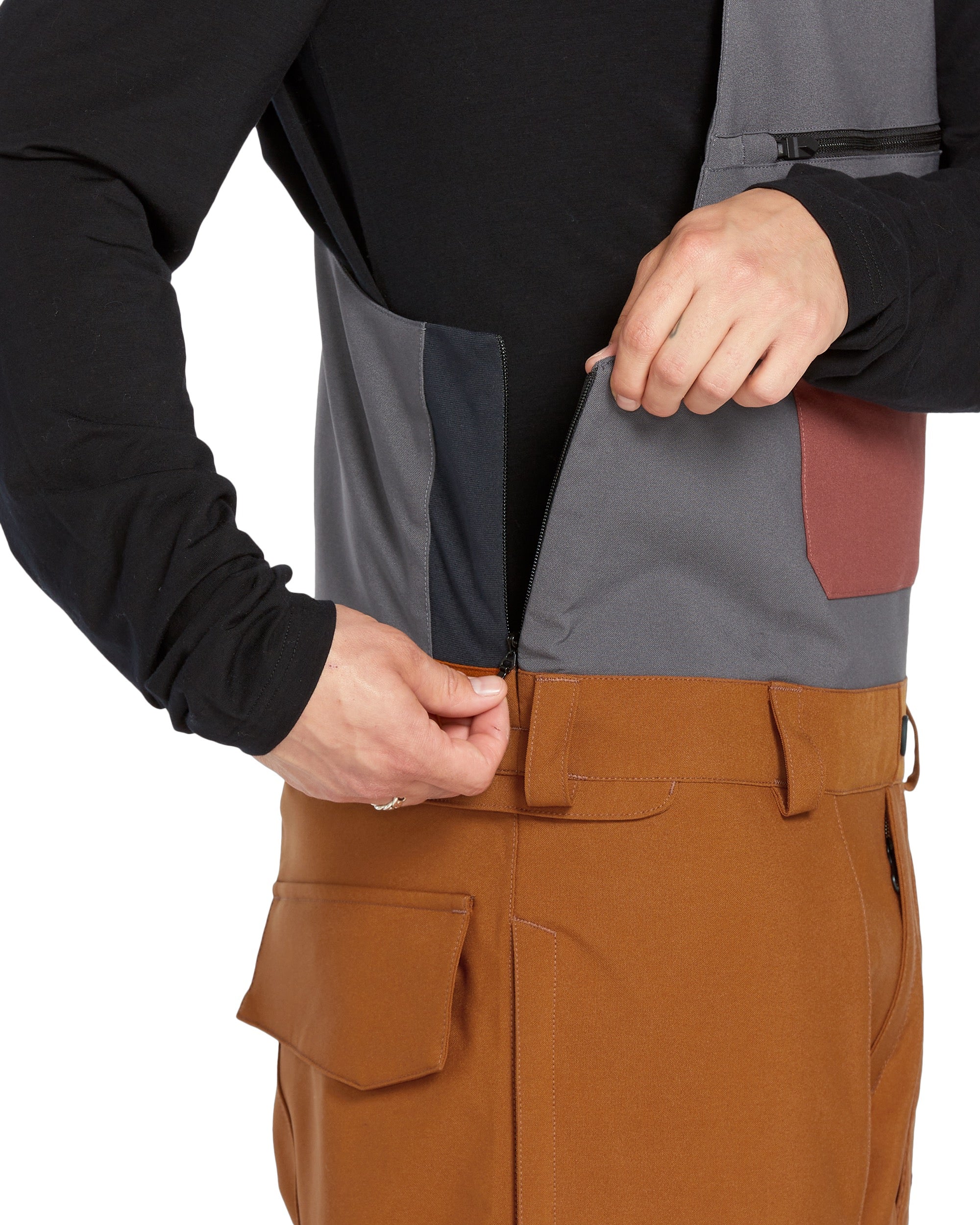 Volcom Men's Roan Shell Bib Overall - A black bib overall with a grey chest pocket and brown accents on the side pockets.