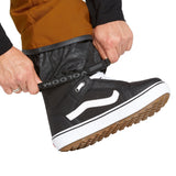 Volcom Men's Roan Shell Bib Overall - A pair of brown snow pants with a black zipper and white drawstring.