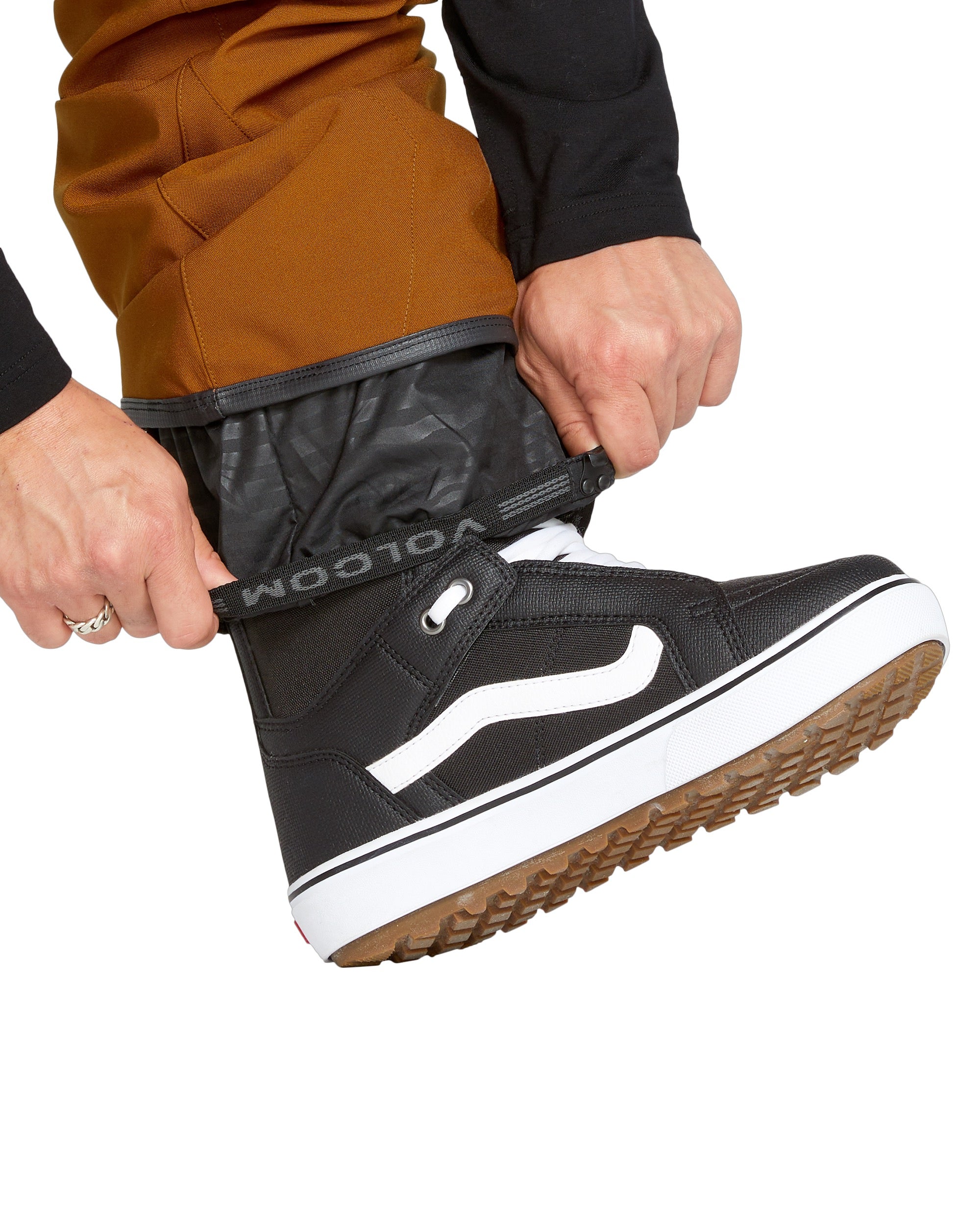 Volcom Men's Roan Shell Bib Overall - A pair of brown snow pants with a black zipper and white drawstring.