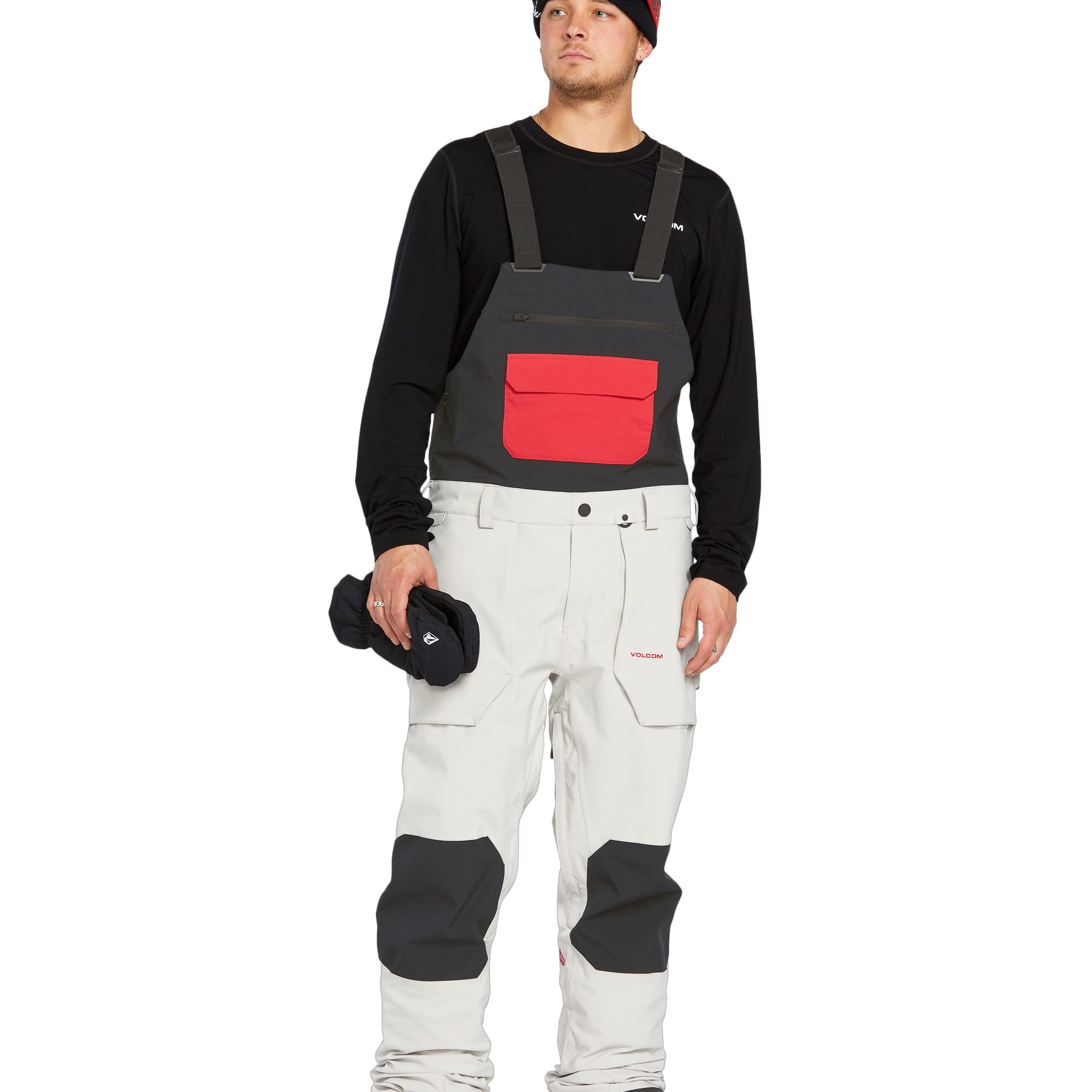 Volcom Men's Roan Shell Bib Overall - A black bib overall with a red zipper and two zippered pockets on the front.