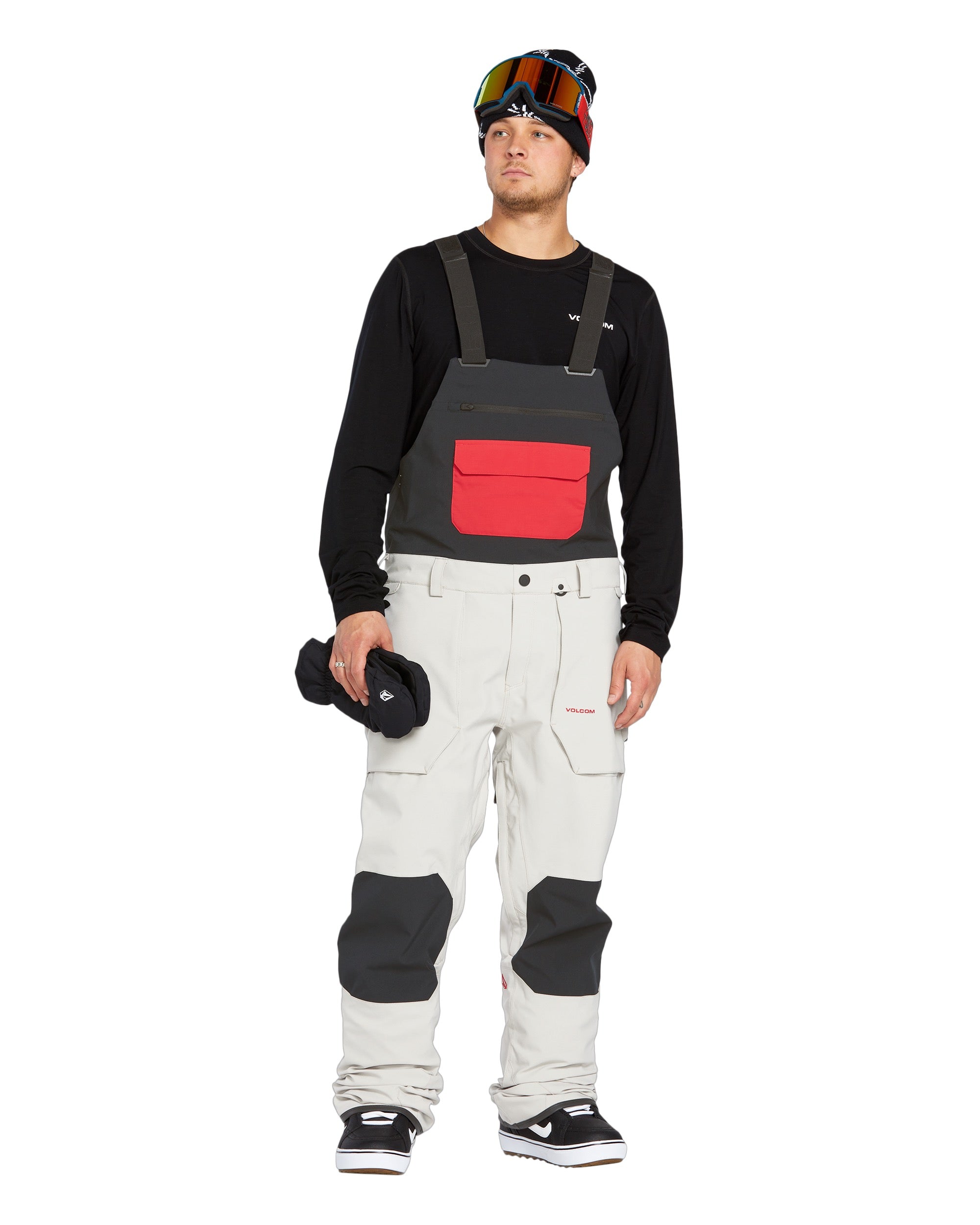 Volcom Men's Roan Shell Bib Overall - A black bib overall with a red zipper and two zippered pockets on the front.