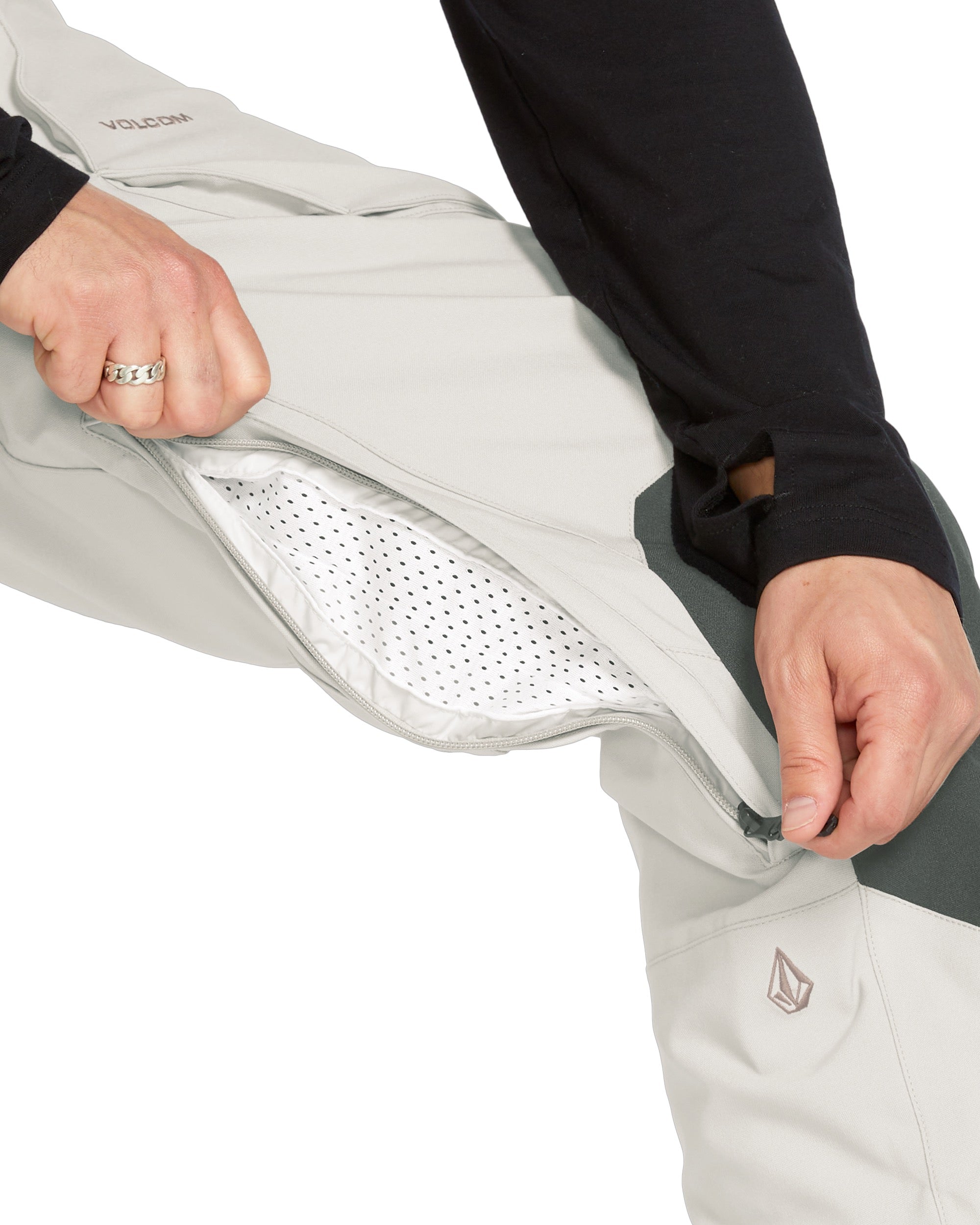 Volcom Men's Roan Shell Bib Overall - A light gray bib overall with a zippered fly and adjustable Velcro straps at the waist and ankles.