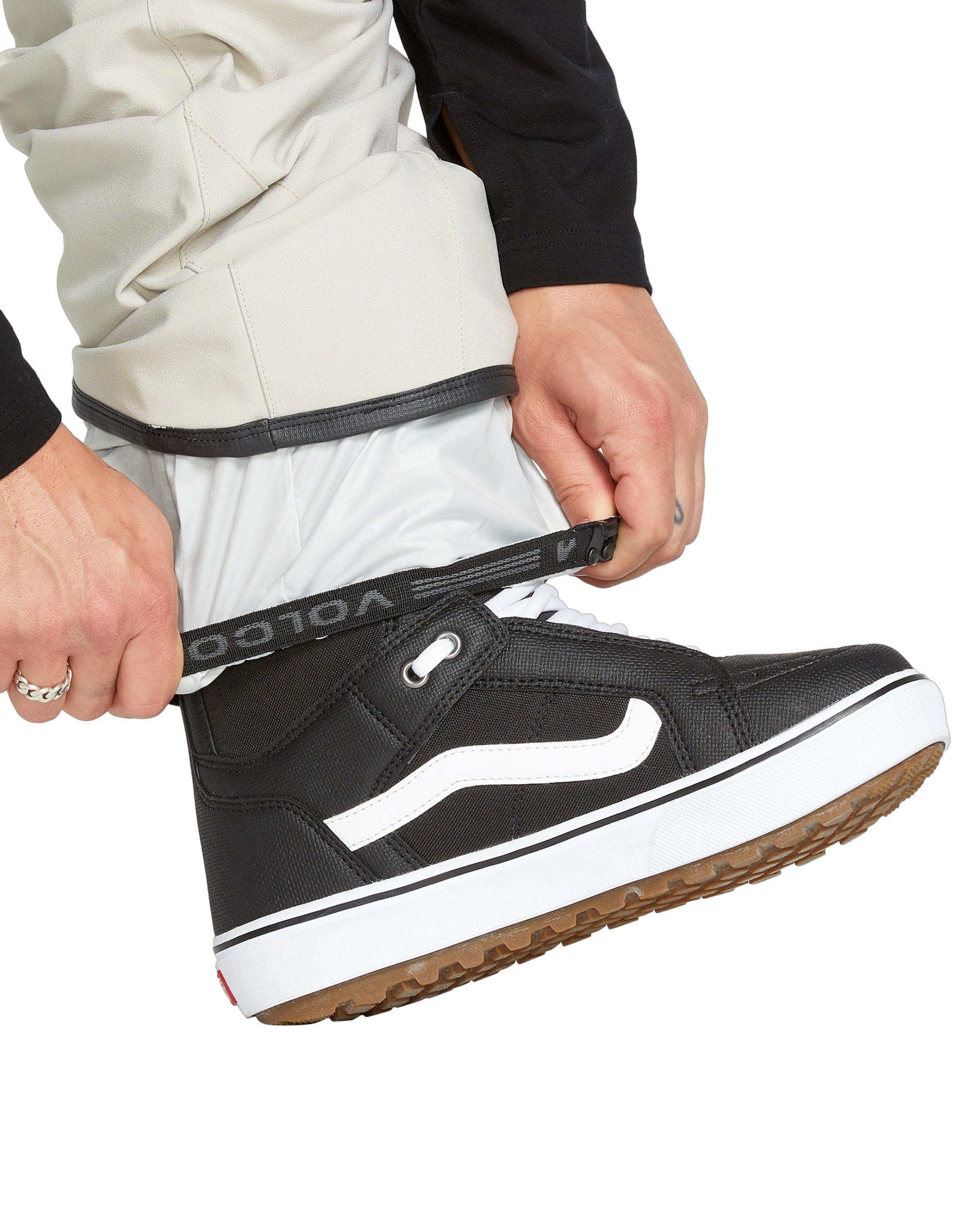 Volcom Men's Roan Shell Bib Overall - A pair of khaki-colored snow bib overalls with a zippered fly and two front pockets.