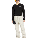 Volcom Men's Roan Shell Pant 2025 - A black snow pant with a zippered pocket on the thigh and a logo patch on the left leg.