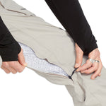 Volcom Men's Roan Shell Pant - A pair of khaki-colored snow pants with a zippered pocket on the thigh and a black logo on the left leg.