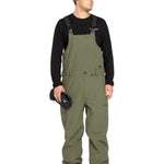 Volcom Men's V.Co Sparta Bib Overall - Olive green bib overalls with black straps and a small white logo on the left leg.