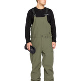 Volcom Men's V.Co Sparta Bib Overall - Olive green bib overalls with black straps and a small white logo on the left leg.
