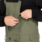 Volcom Men's V.Co Sparta Bib Overall - Olive green bib overalls with adjustable straps and black buckles.