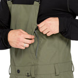 Volcom Men's V.Co Sparta Bib Overall - Olive green bib overalls with adjustable straps and black buckles.
