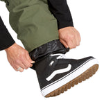 Volcom Men's V.Co Sparta Bib Overall - A pair of olive green snow pants with a black zipper and white drawstring on the waistband.