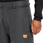 Volcom Men's Arthur 20K Shell Pant - Dark gray pants with a zippered pocket on the right thigh and a small logo patch near the bottom left leg.
