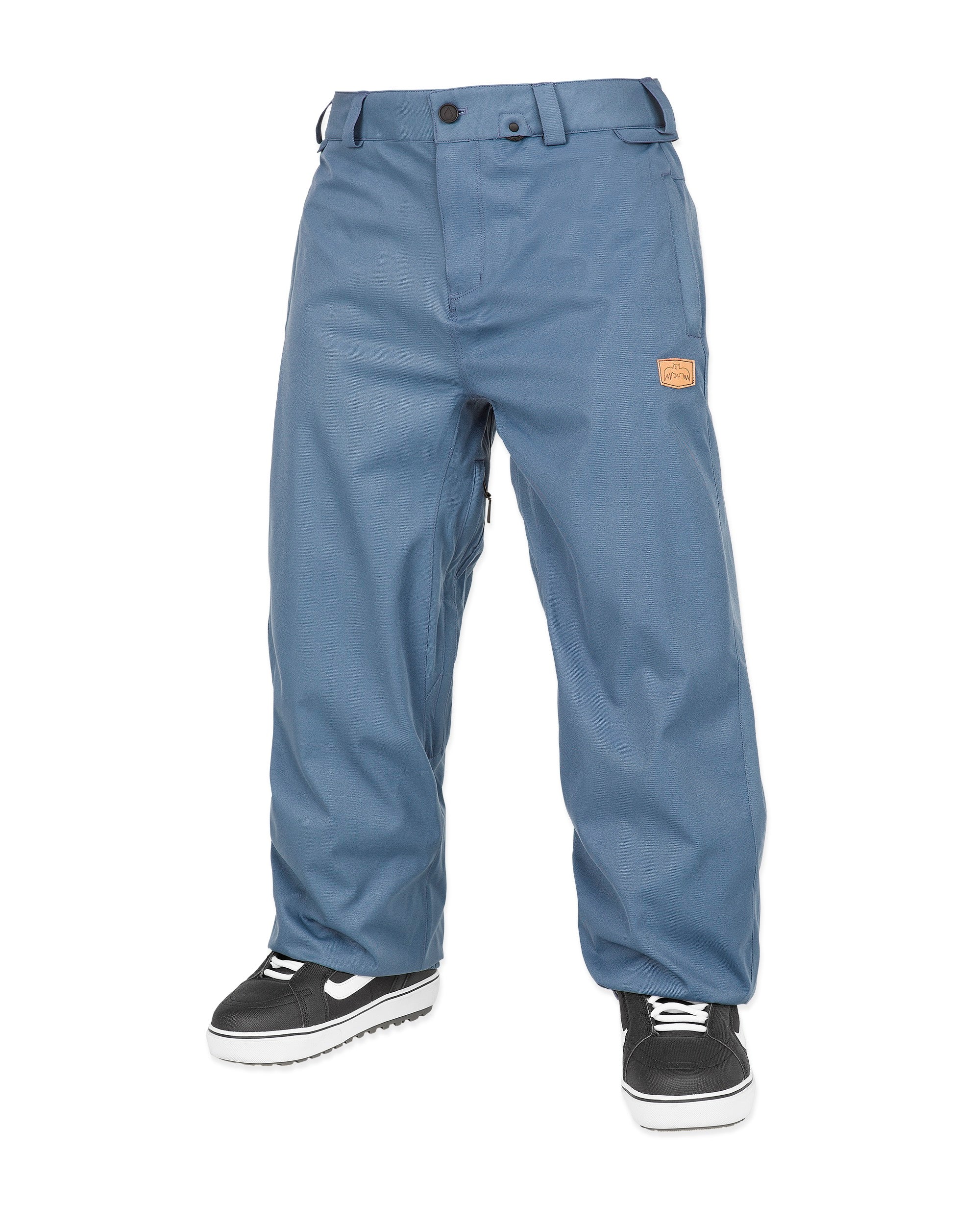 Volcom Men's Arthur 20K Shell Pant - A pair of blue snow pants with a brown leather patch on the upper thigh, featuring a belt loop and two zippered pockets.