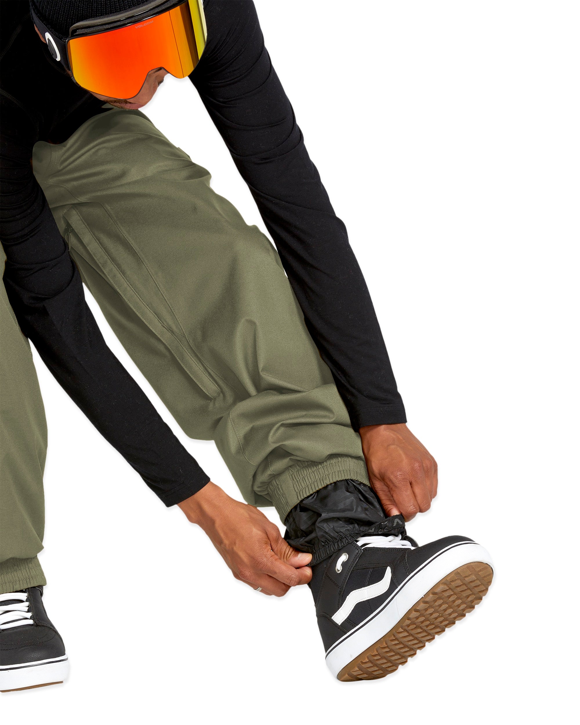 Volcom Men's Arthur 20K Shell Pant - A pair of olive green snow pants with a zippered pocket on the side and adjustable Velcro straps at the ankles.