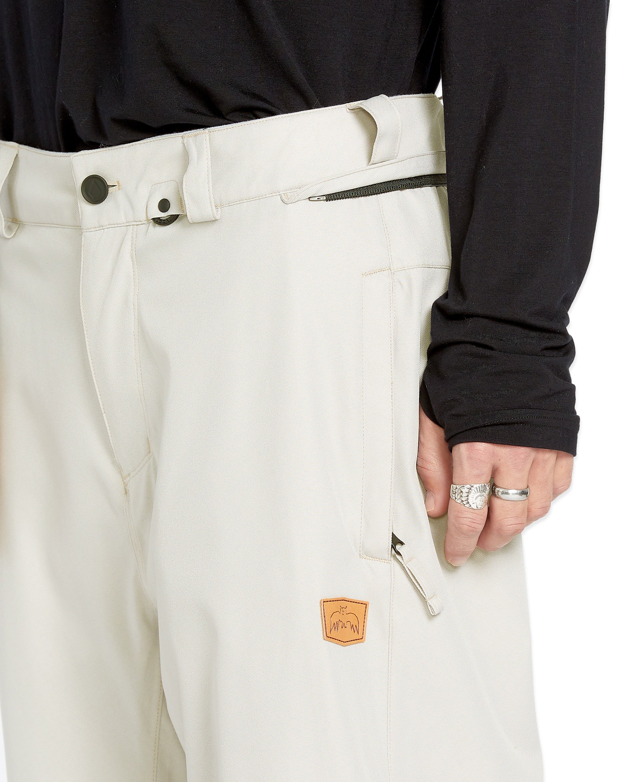 Volcom Men's Arthur 20K Shell Pant - A pair of white snow pants with a zippered pocket on the side and a black zipper pull.