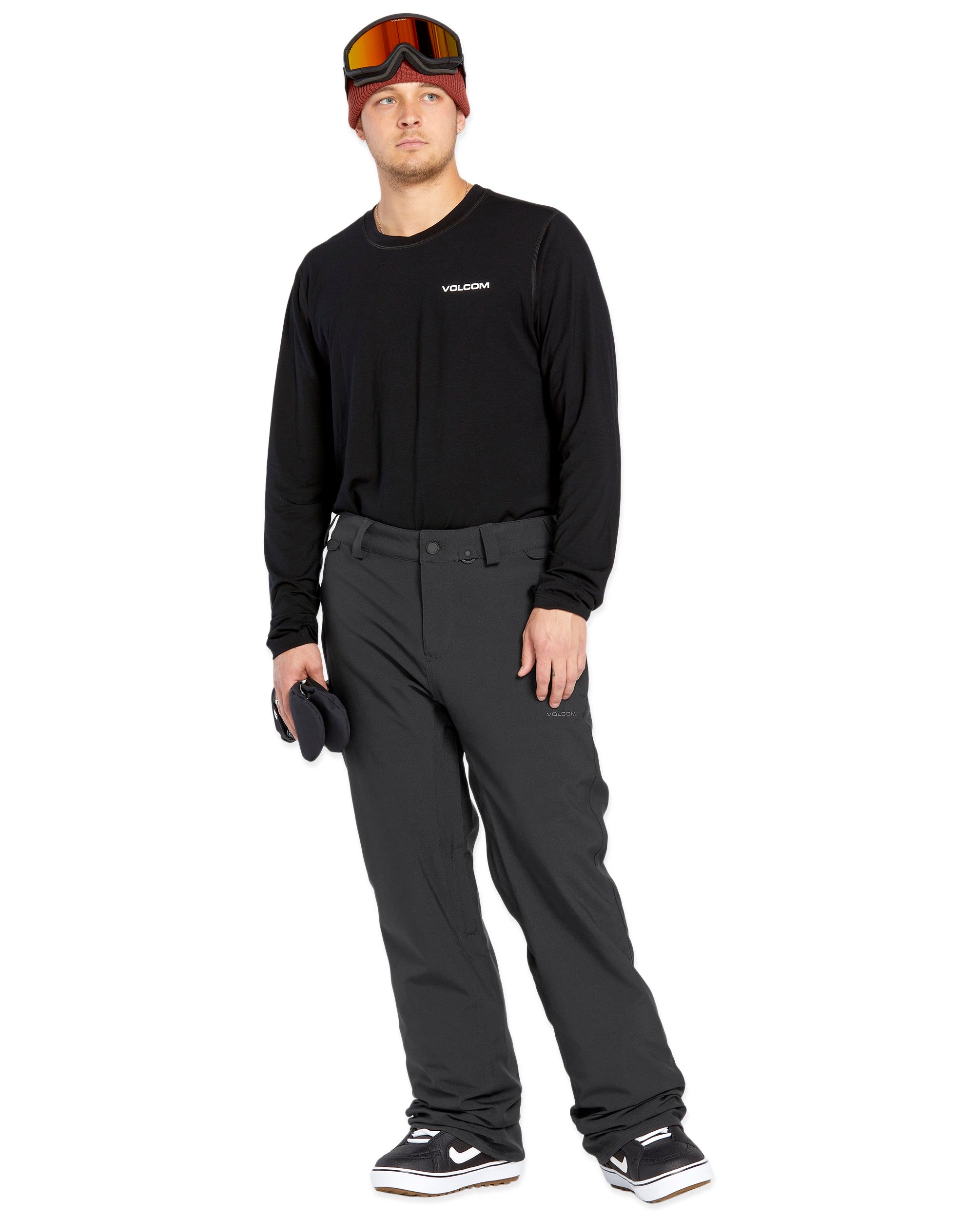 Volcom Men's Freakin' Snow Chino Pant - A pair of black snow pants with a subtle white stripe on the side seam.
