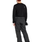 Volcom Men's Freakin' Snow Chino Pant - Black snow pants with a subtle white logo on the left thigh and a small white tag on the right waistband.