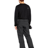Volcom Men's Freakin' Snow Chino Pant - Black snow pants with a subtle white logo on the left thigh and a small white tag on the right waistband.