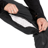 Volcom Men's Freakin' Snow Chino Pant - Black snow pants with a zippered pocket on the side and a small logo embroidered near the bottom of the leg.
