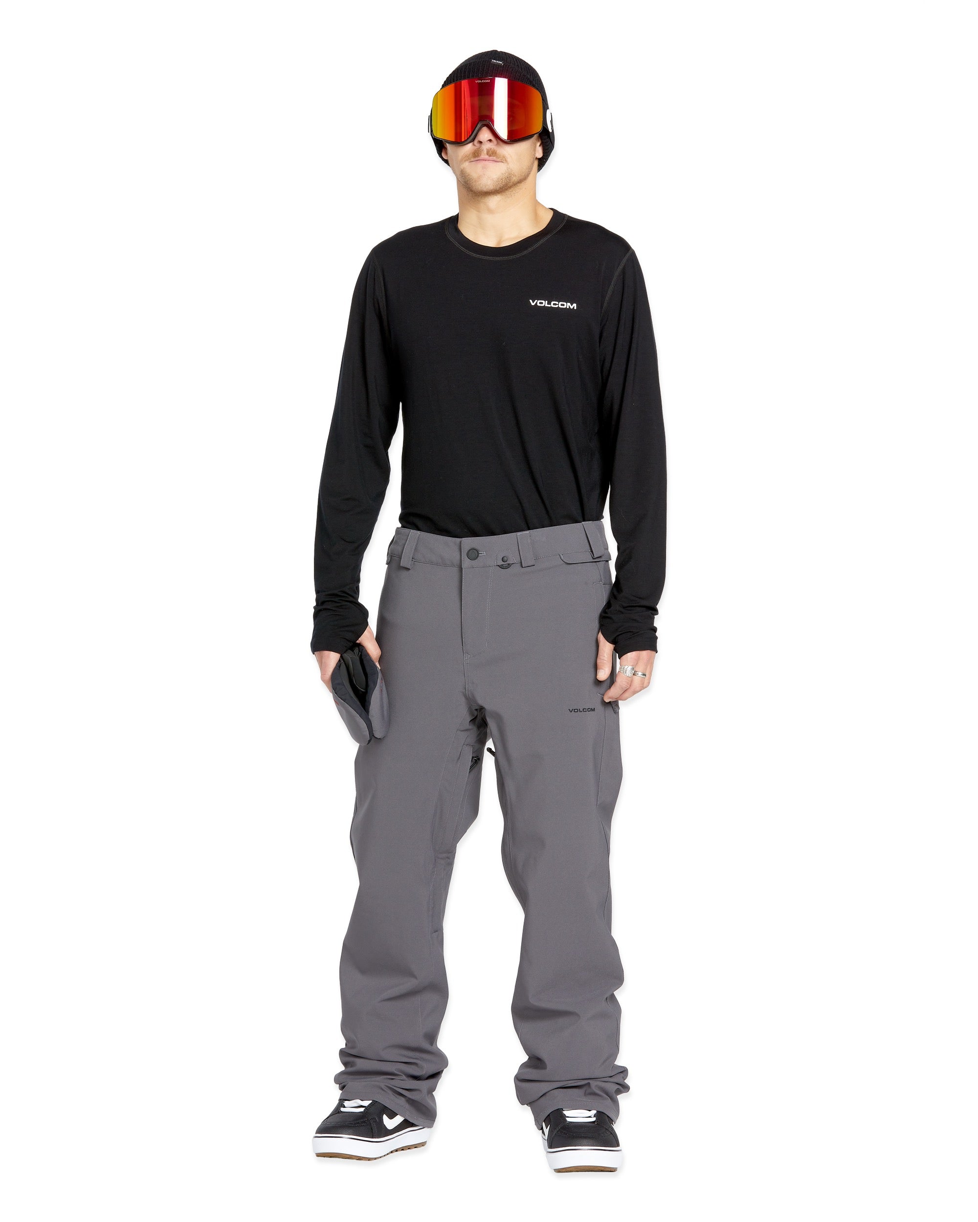 Volcom Men's Freakin' Snow Chino Pant - A pair of gray snow pants with a subtle pattern and multiple pockets.