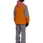 Volcom Men's Freakin' Snow Chino Pant 2025 - A pair of dark-washed, straight-leg chinos with a subtle snowboarder graphic on the left leg.