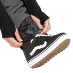 Volcom Men's Freakin' Snow Chino Pant - A pair of black snow pants with a subtle gray pattern on the side pockets and a white drawstring.