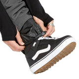 Volcom Men's Freakin' Snow Chino Pant - A pair of black snow pants with a subtle gray pattern on the side pockets and a white drawstring.