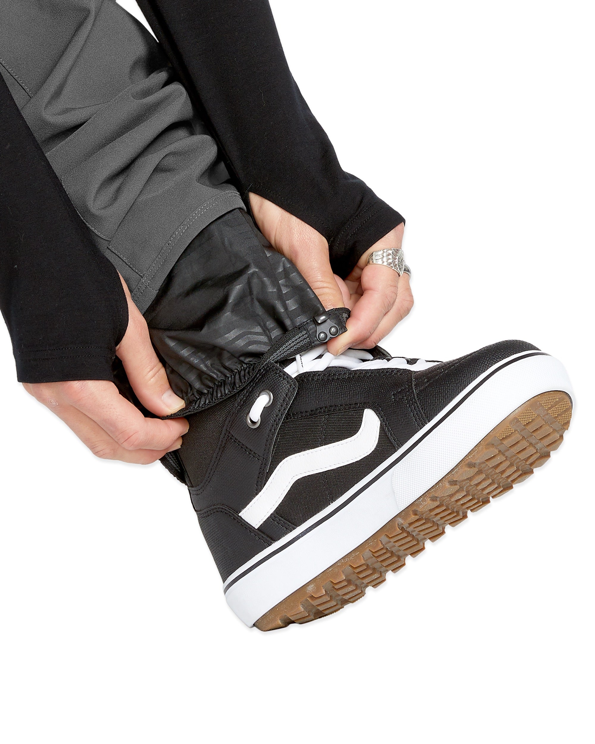 Volcom Men's Freakin' Snow Chino Pant - A pair of black snow pants with a subtle gray pattern on the side pockets and a white drawstring.