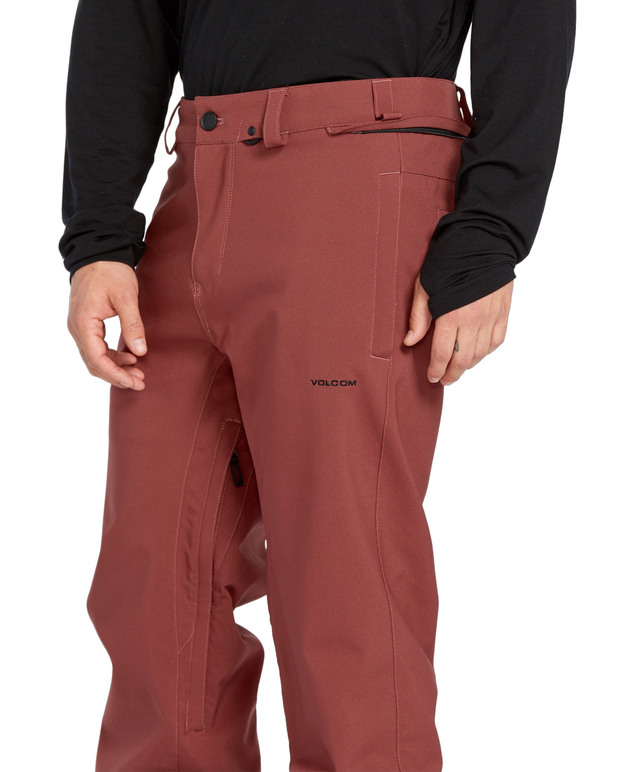 Volcom Men's Freakin' Snow Chino Pant 2025 - A pair of red snow pants with a black zipper on the side and two belt loops at the waist.