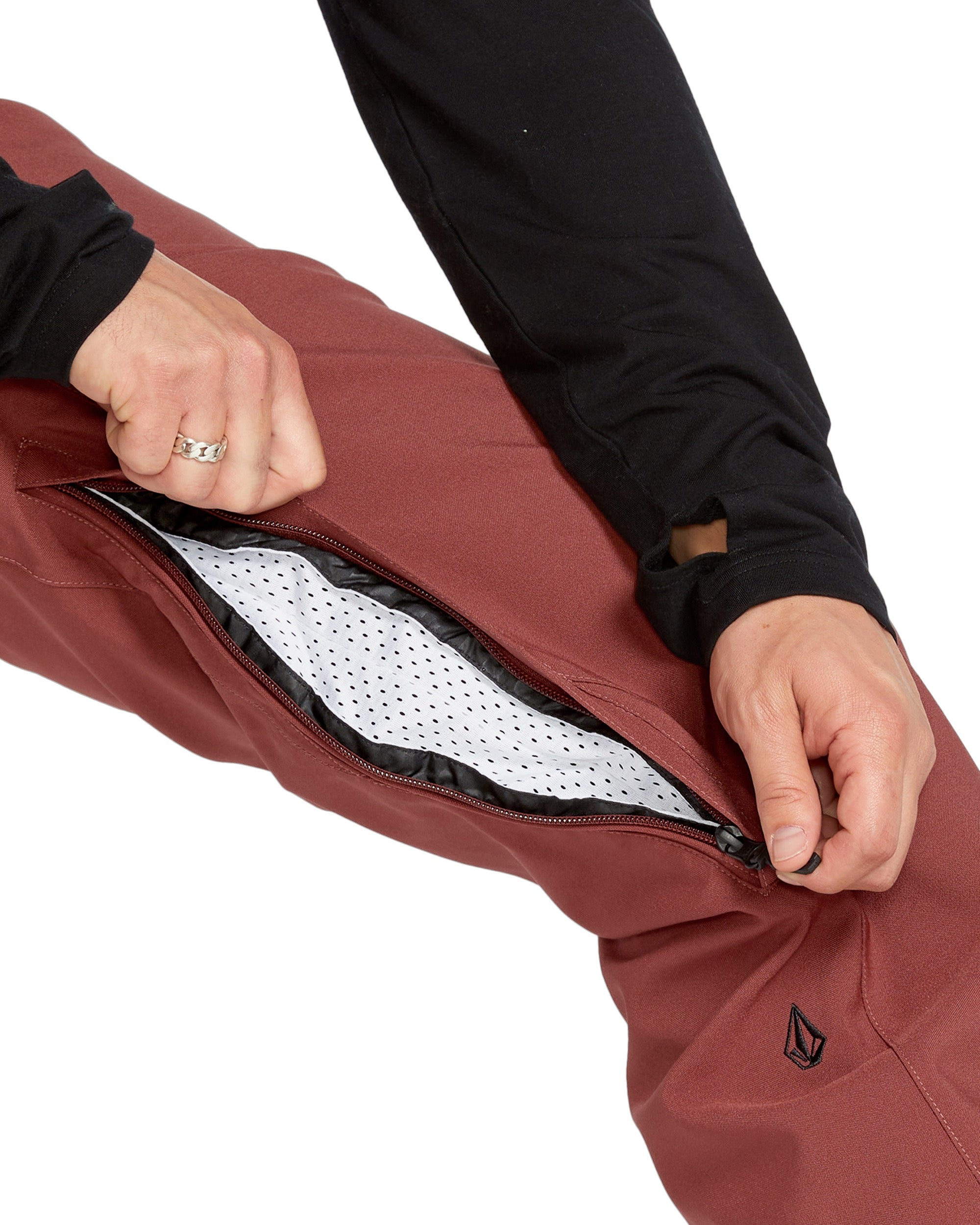 Volcom Men's Freakin' Snow Chino Pant - A pair of brown snow pants with a black zipper and logo on the left leg.
