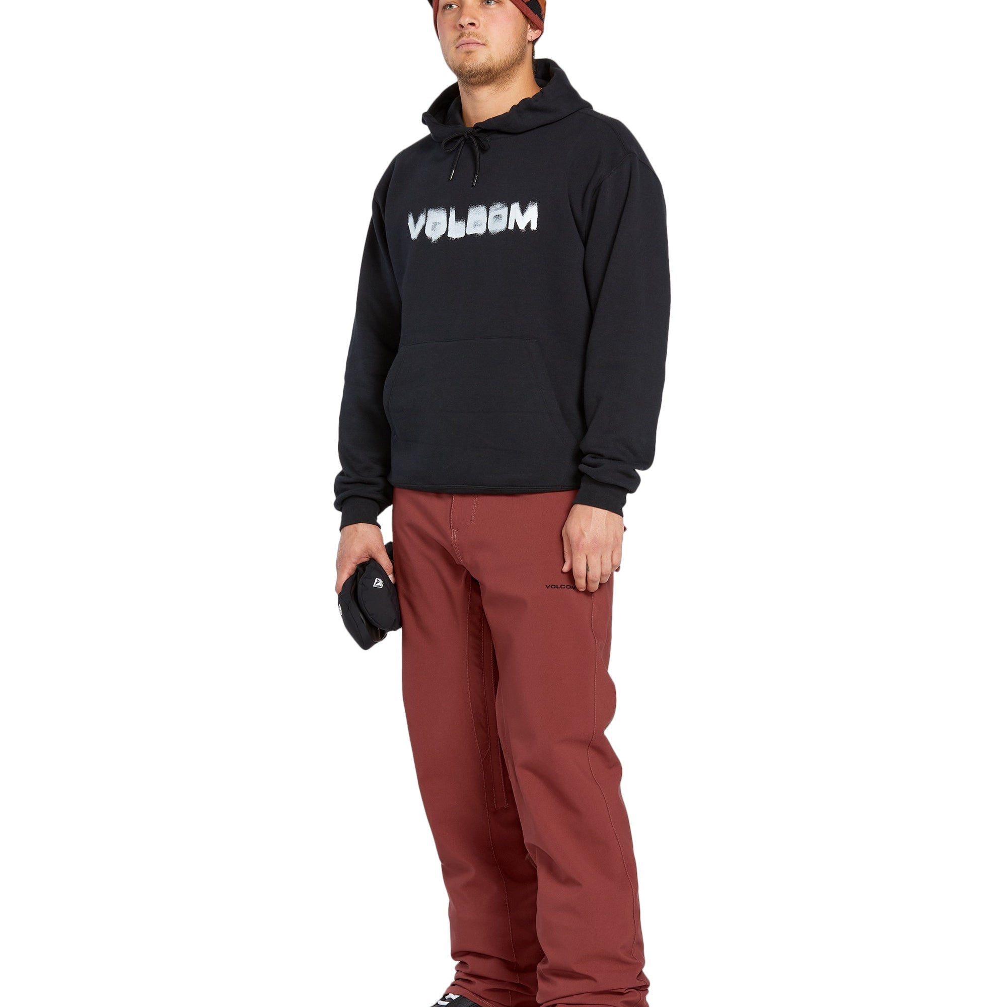 Volcom Men's Freakin' Snow Chino Pant 2025 - A pair of brown snow pants with a zippered pocket on the side and a logo patch on the left thigh.