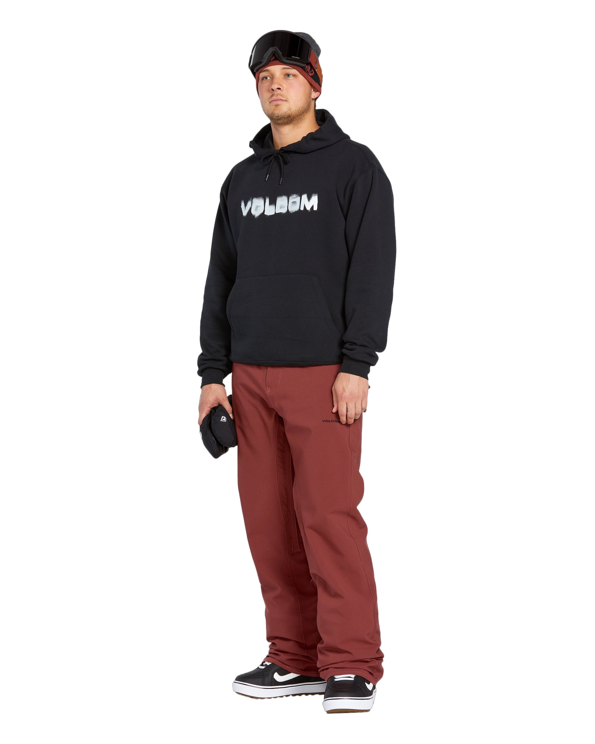 Volcom Men's Freakin' Snow Chino Pant 2025 - A pair of brown snow pants with a zippered pocket on the side and a logo patch on the left thigh.