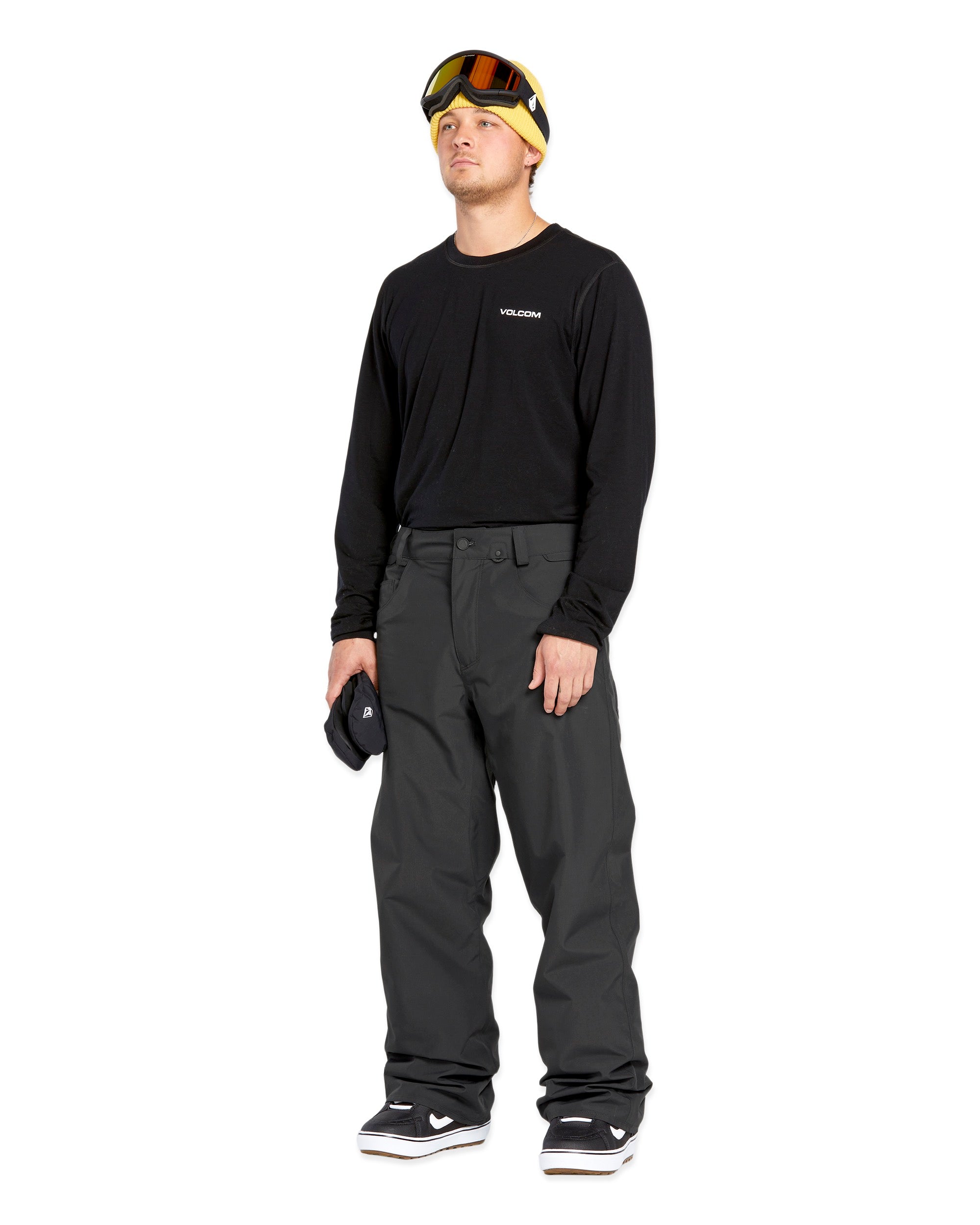 Volcom Men's 5 Pocket Shell Pant - Black pants with white logo on left thigh and two zippered pockets on right side.