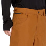 Volcom Men's 5 Pocket Shell Pant - A pair of khaki-colored snow pants with five pockets, including two zippered thigh pockets and three open cargo pockets.