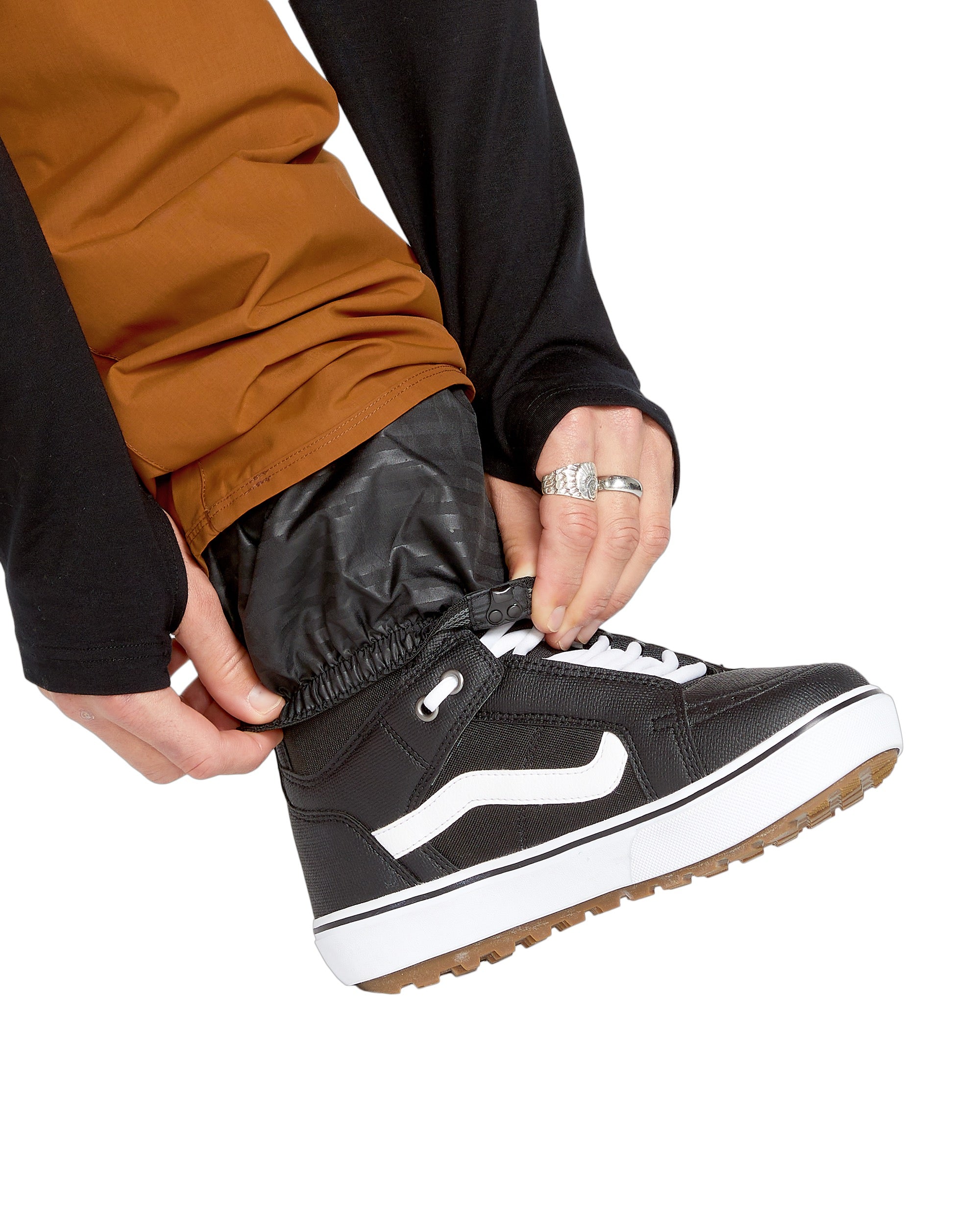 Volcom Men's 5-Pocket Shell Pant - A pair of black pants with five pockets, featuring a zippered fly and elastic waistband.