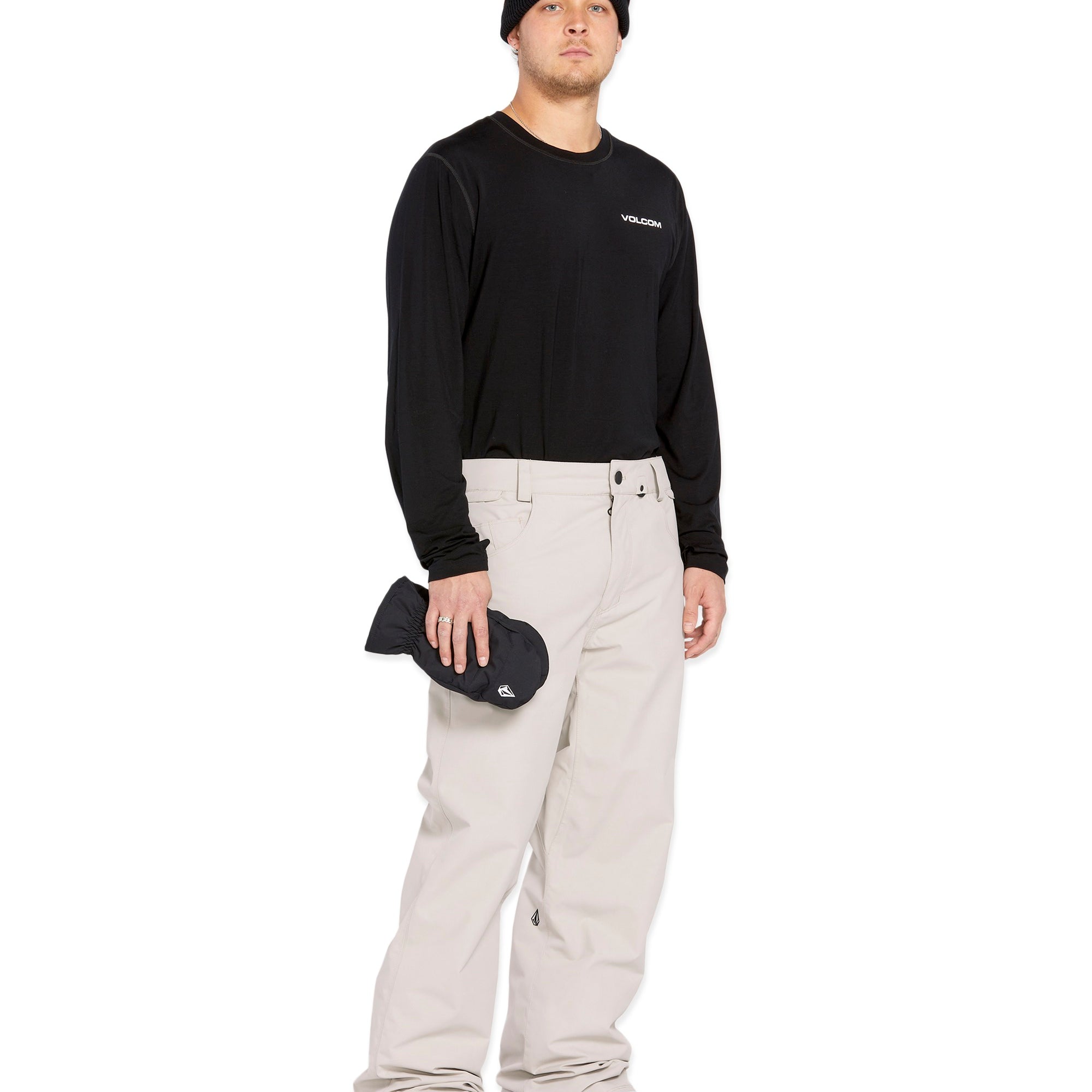Volcom Men's 5 Pocket Shell Pant - Black pants with white logo on left thigh and two zippered pockets on right side.