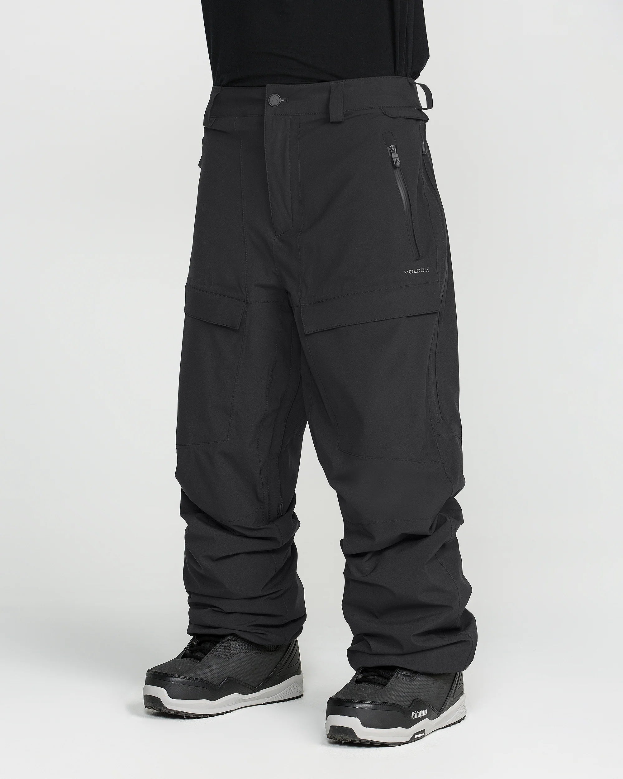 Black snowboarding pants with cargo pocket panels and stitched knee seams