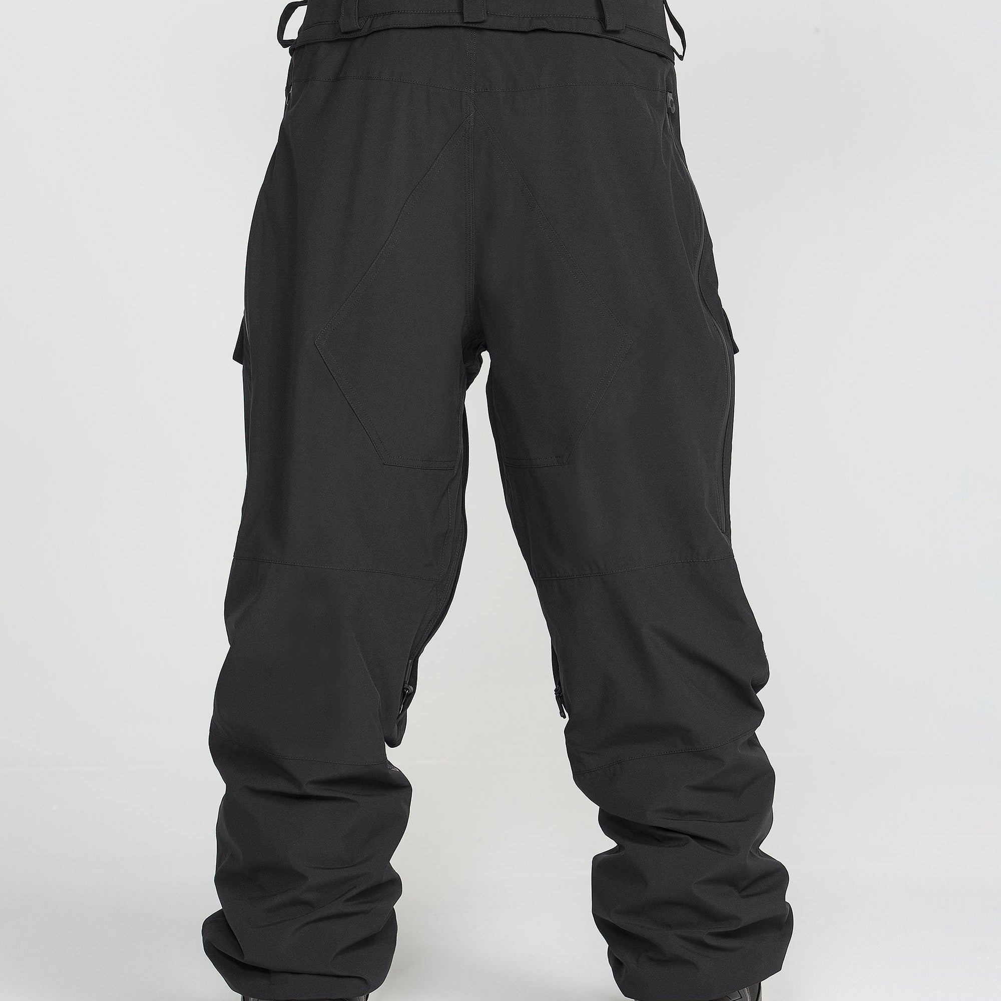 Black ski pants with belt loops, cargo pockets, and articulated knee panels