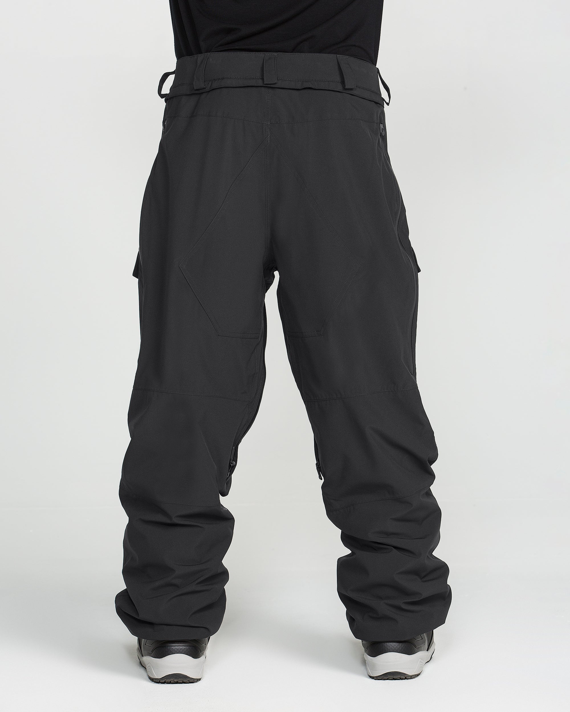 Black ski pants with belt loops, cargo pockets, and articulated knee panels